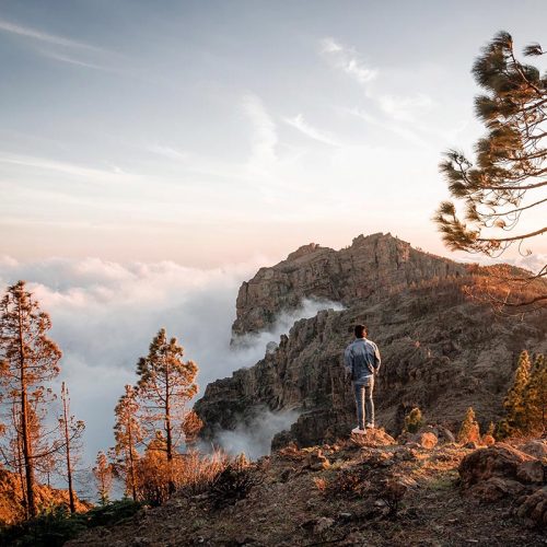 young-man-enjoying-sea-of-clouds-sunset-among-the-2021-04-05-13-02-29-utc-copy
